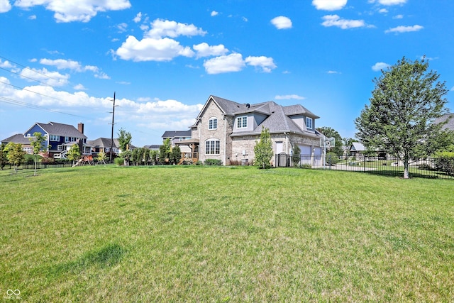 view of front of property with a front lawn and a garage