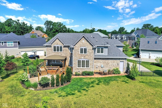 back of property featuring a lawn and a gazebo