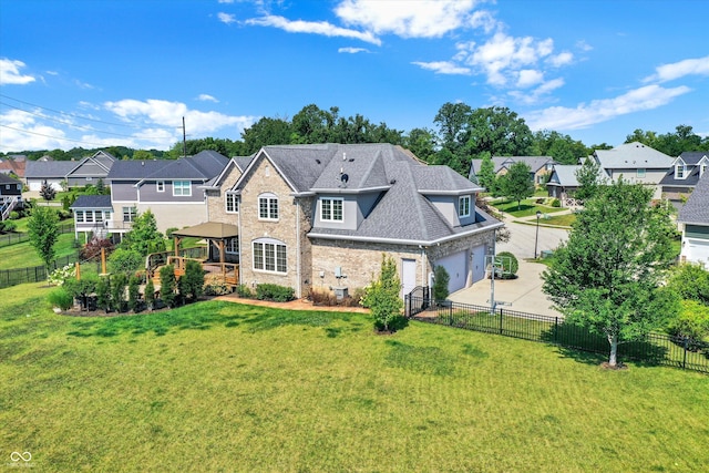 back of house with a gazebo, a yard, and a garage