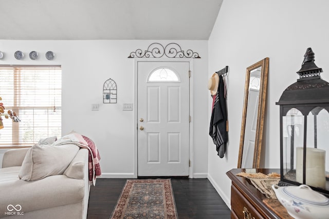 entrance foyer with dark wood finished floors and baseboards