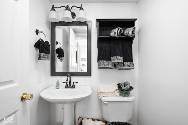 bathroom featuring toilet and a sink