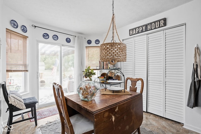 dining area featuring a textured ceiling