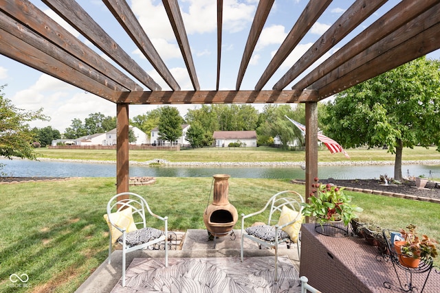 view of patio / terrace with a pergola, a water view, and an outdoor fire pit