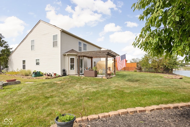 rear view of property with a patio, a pergola, a yard, and fence