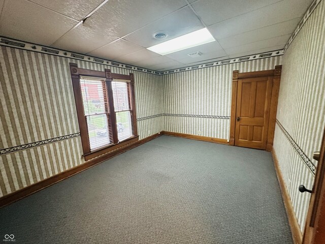 carpeted spare room with baseboards, visible vents, and wallpapered walls
