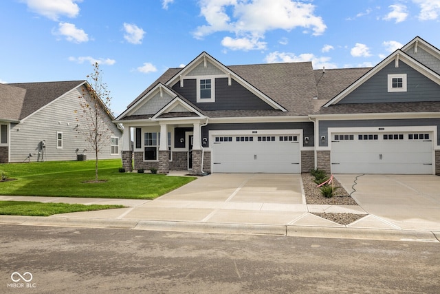 craftsman house featuring a garage and a front lawn