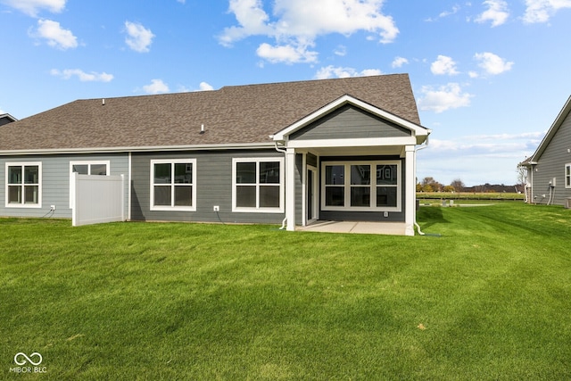 back of property featuring a patio area and a yard