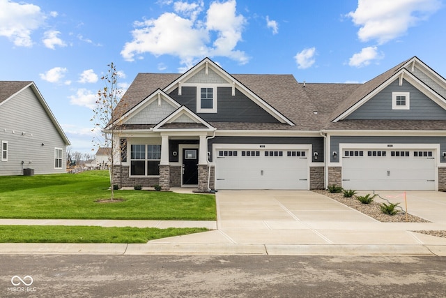 craftsman house with central AC unit and a front lawn