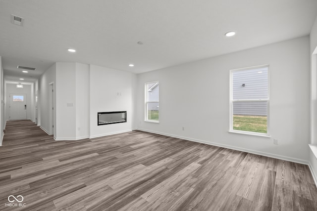 unfurnished living room with wood-type flooring