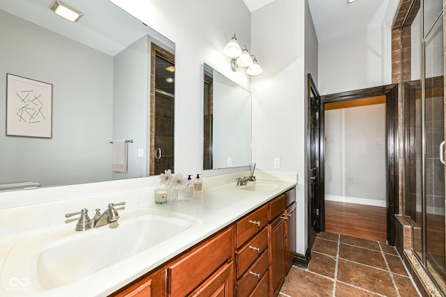 bathroom featuring vanity and an enclosed shower