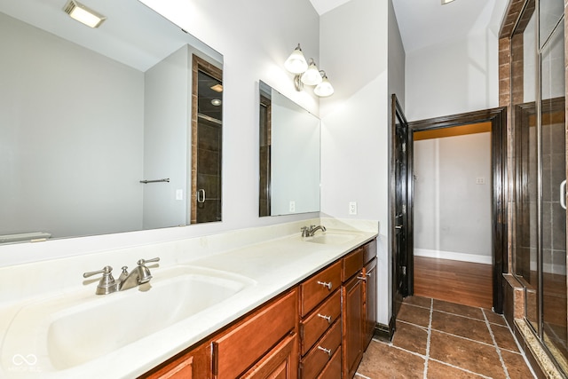 bathroom featuring vanity and an enclosed shower