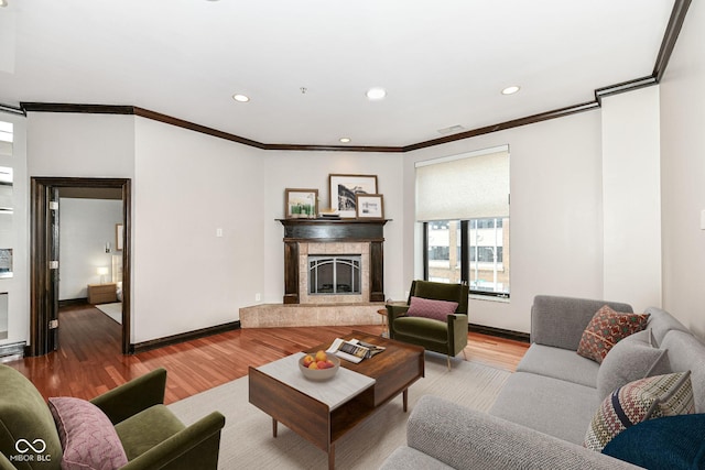 living room featuring wood-type flooring and ornamental molding