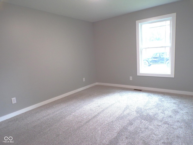 unfurnished room with carpet flooring