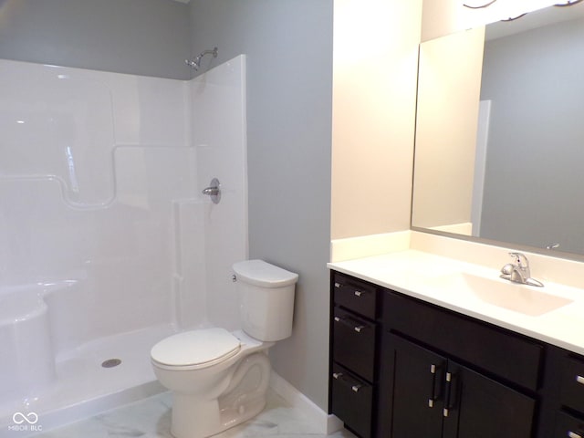 bathroom with vanity, toilet, and a shower