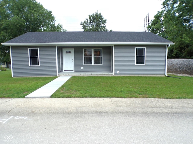 single story home with covered porch and a front lawn