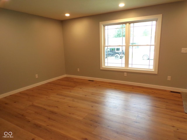 empty room with light hardwood / wood-style flooring