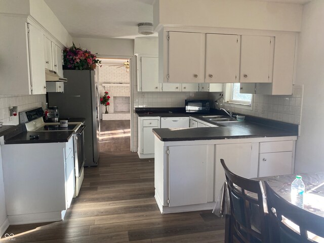 kitchen featuring white cabinetry, range with electric cooktop, tasteful backsplash, dark wood-type flooring, and white dishwasher