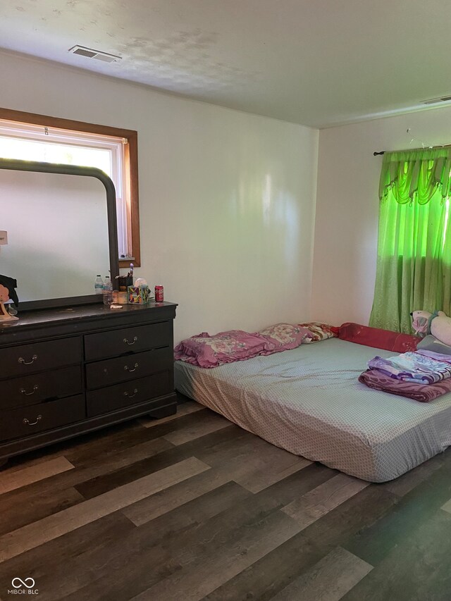 bedroom featuring dark wood-type flooring