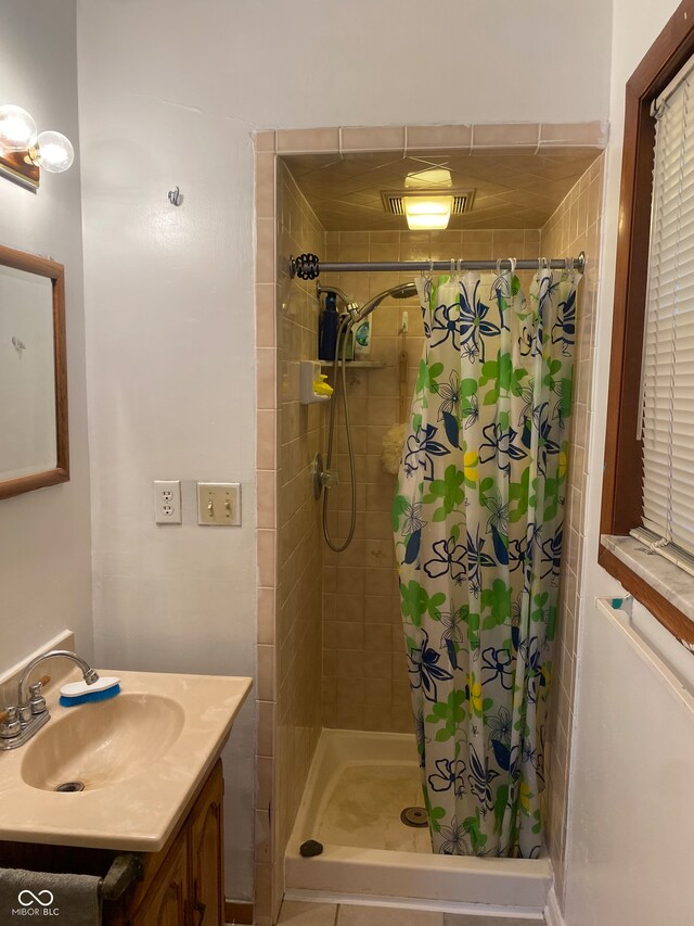 bathroom featuring walk in shower and vanity