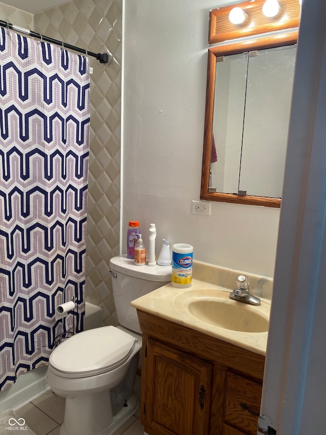 bathroom featuring toilet, vanity, and tile patterned floors