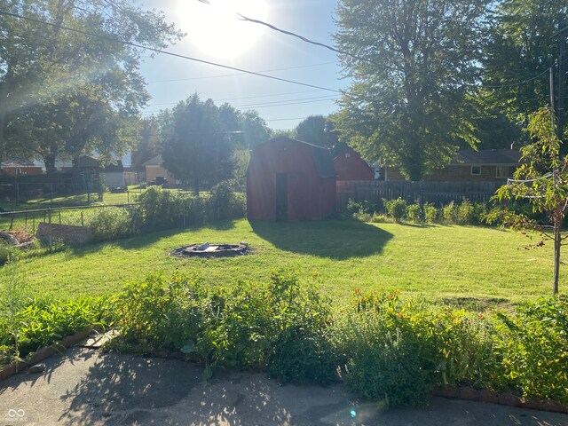 view of yard with a fire pit and a shed