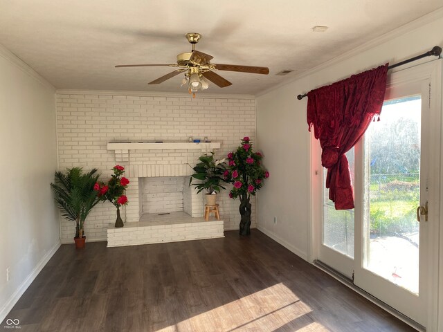 interior space with brick wall, a healthy amount of sunlight, ornamental molding, and dark hardwood / wood-style floors