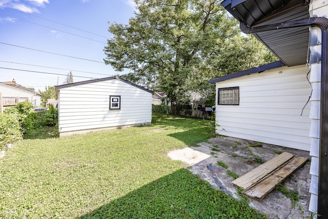 view of yard with an outdoor structure and fence