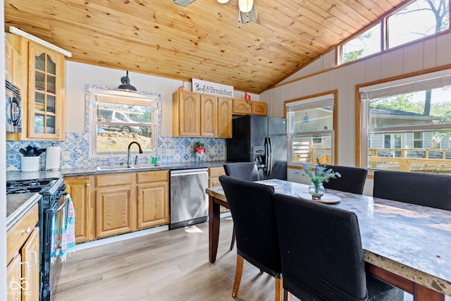 kitchen featuring light wood-style floors, vaulted ceiling, a sink, wooden ceiling, and black appliances