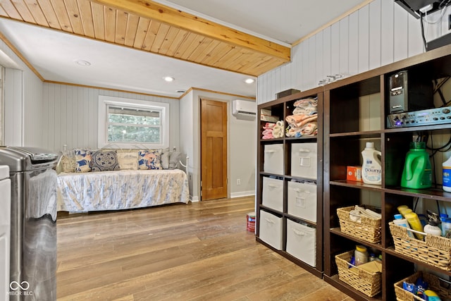 bedroom with ornamental molding, a wall mounted air conditioner, wood finished floors, and recessed lighting