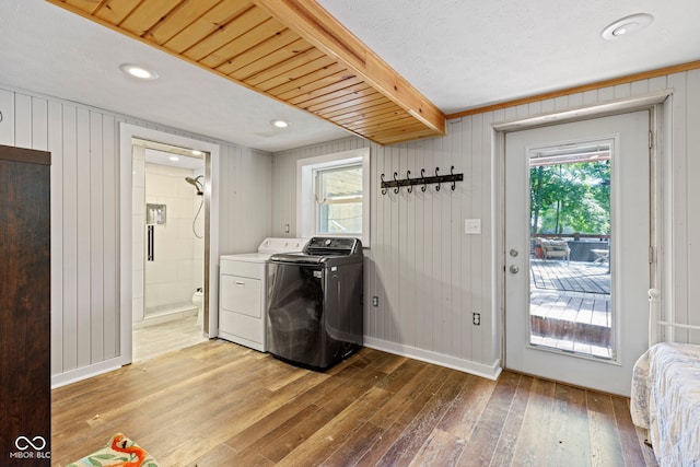 washroom with washing machine and clothes dryer, recessed lighting, light wood-style flooring, laundry area, and baseboards