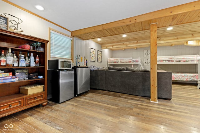 kitchen with recessed lighting, wood-type flooring, stainless steel refrigerator, and freestanding refrigerator