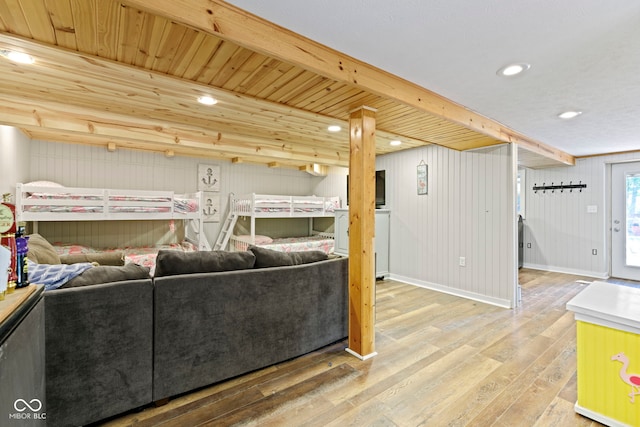 living area featuring recessed lighting, beamed ceiling, baseboards, and wood finished floors