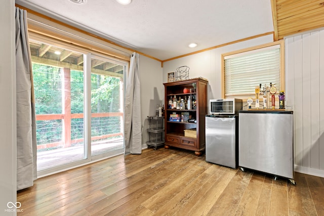 kitchen featuring fridge, stainless steel refrigerator, and light wood finished floors