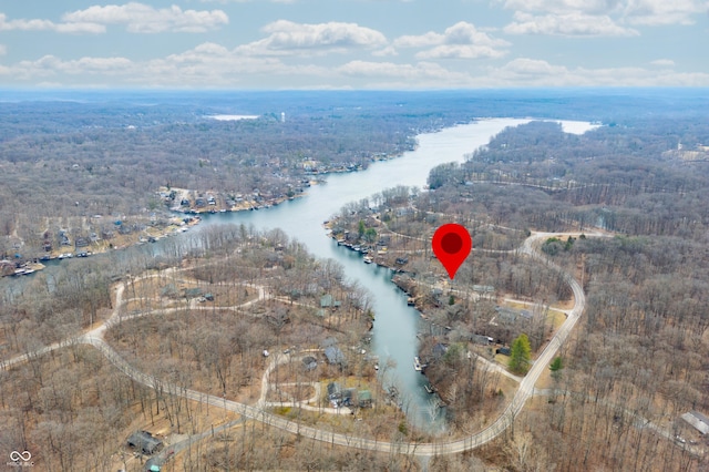 bird's eye view with a water view and a wooded view