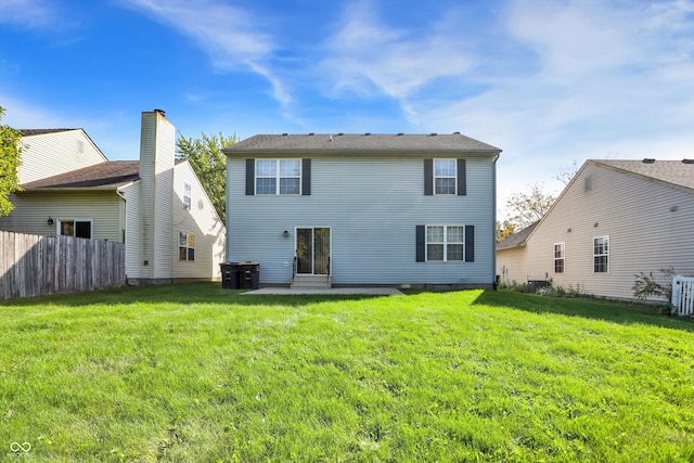 rear view of house featuring a yard, a patio area, and fence