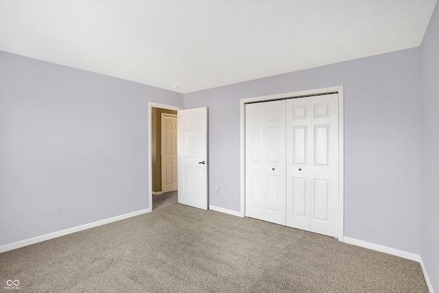 unfurnished bedroom with a closet, baseboards, and carpet floors