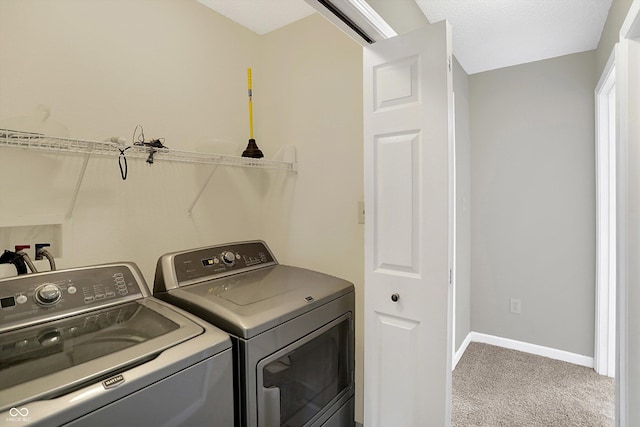 washroom featuring laundry area, baseboards, carpet floors, and washing machine and clothes dryer