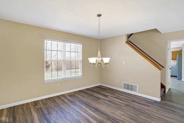 unfurnished dining area with dark wood-type flooring, stairway, baseboards, and visible vents