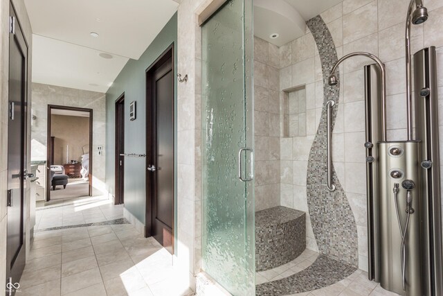 bathroom featuring a shower with door and tile patterned floors