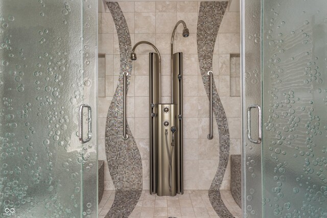 bathroom featuring a shower with shower door