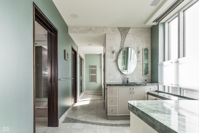 bathroom featuring vanity, tile walls, and tile patterned floors