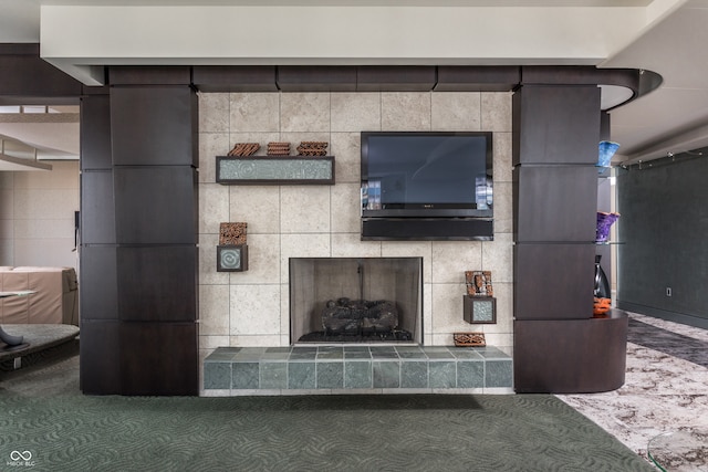 living room with tile walls and a tiled fireplace