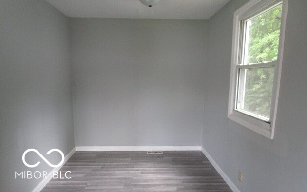 empty room with wood-type flooring