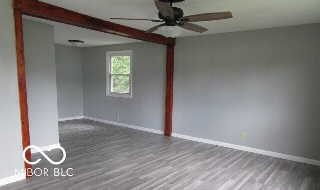 empty room with hardwood / wood-style floors and ceiling fan