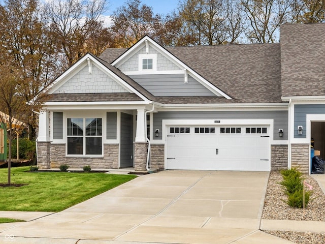 craftsman-style house featuring a garage and a front yard