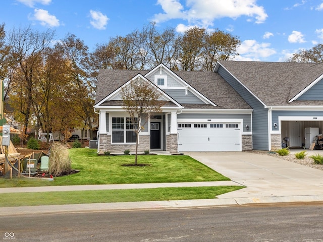 craftsman inspired home featuring a garage and a front yard