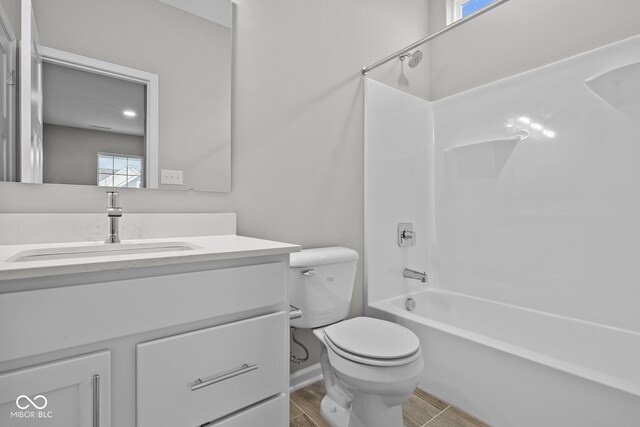 full bathroom featuring shower / bathtub combination, hardwood / wood-style flooring, vanity, and toilet