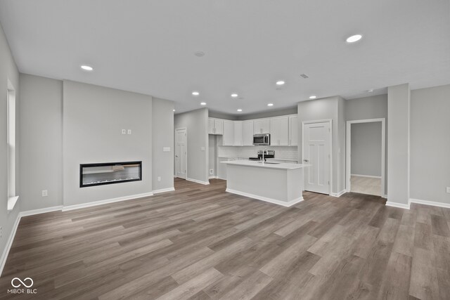 unfurnished living room with light wood-type flooring