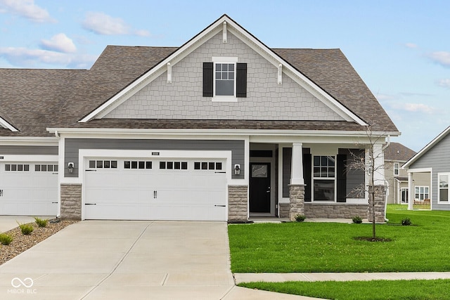 craftsman-style home with a front lawn, a porch, and a garage