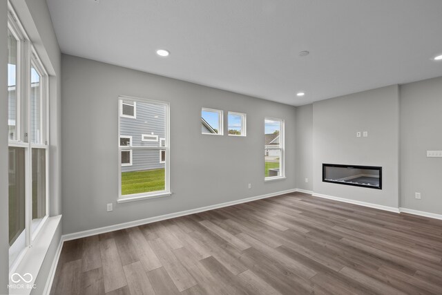 unfurnished living room featuring hardwood / wood-style flooring